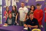 Madison Wallace (left) and Jacob Gonsalves share a proud moment with family and friends as they signed letters-of-intent to play college athletics. 